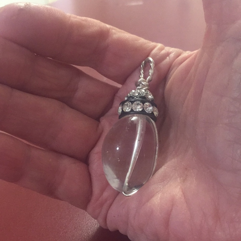 Clear crystal quartz pendant with rhinestones.